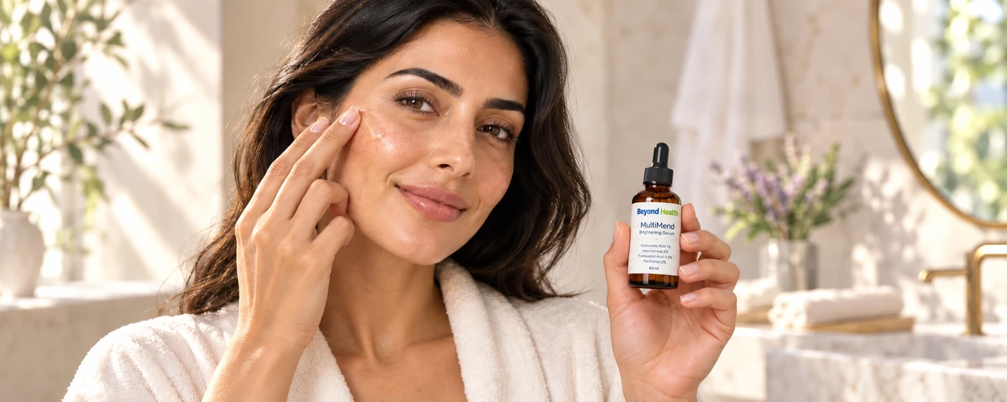 Illustrative lifestyle portrait of a woman applying serum while holding Beyond Health MultiMend